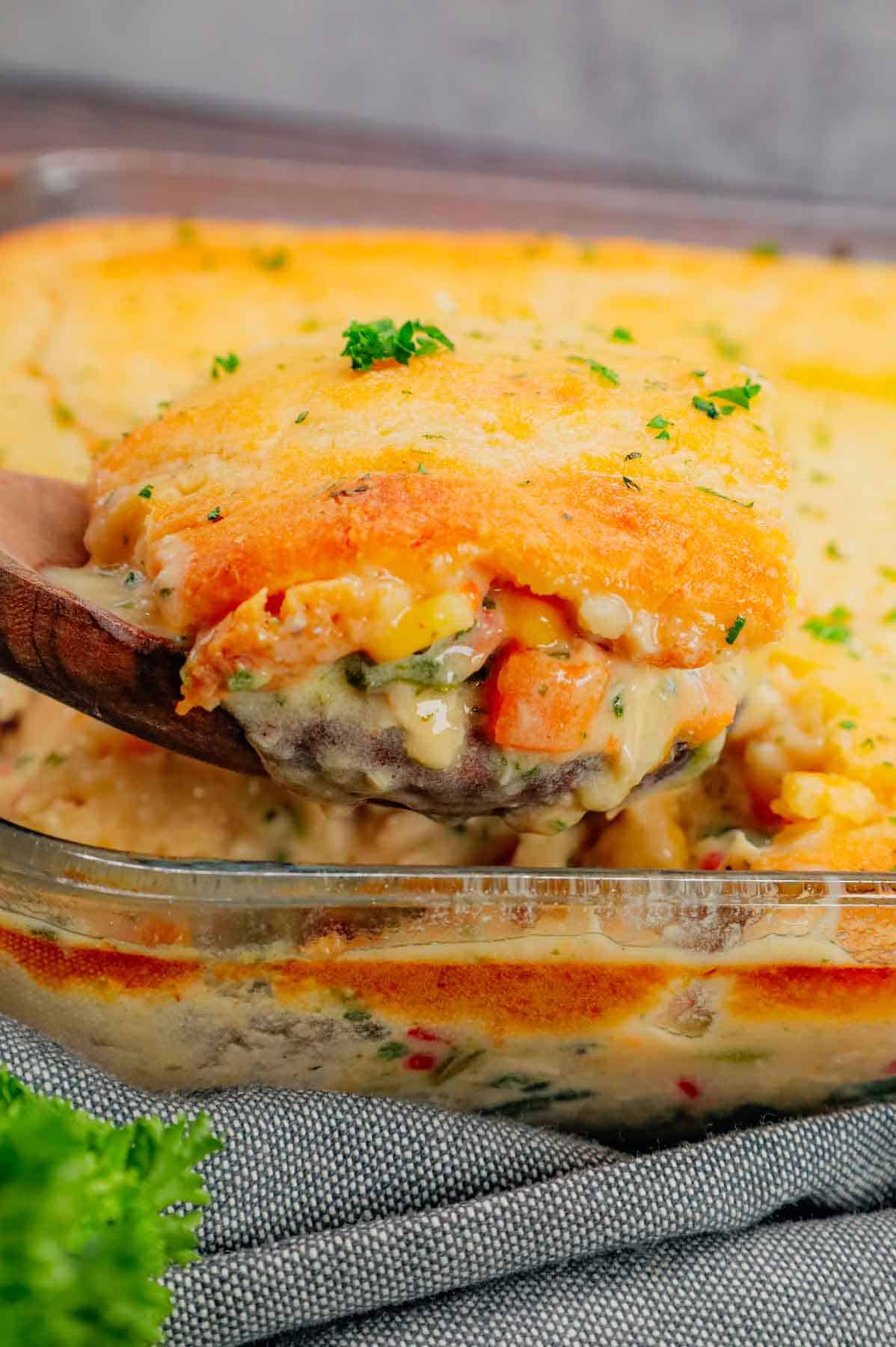 Chicken Cobbler is a hearty dish loaded with shredded rotisserie chicken and veggies all tossed in a mixture of cream of chicken and cream of mushroom soup and topped with Red Lobster Cheddar Bay biscuit mix.