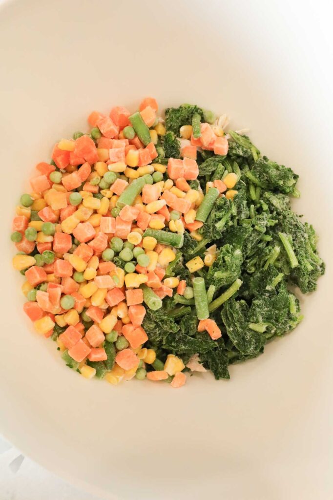 frozen mixed vegetables and chopped spinach in a mixing bowl