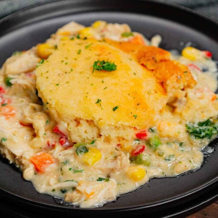 Chicken Cobbler is a hearty dish loaded with shredded rotisserie chicken and veggies all tossed in a mixture of cream of chicken and cream of mushroom soup and topped with Red Lobster Cheddar Bay biscuit mix.