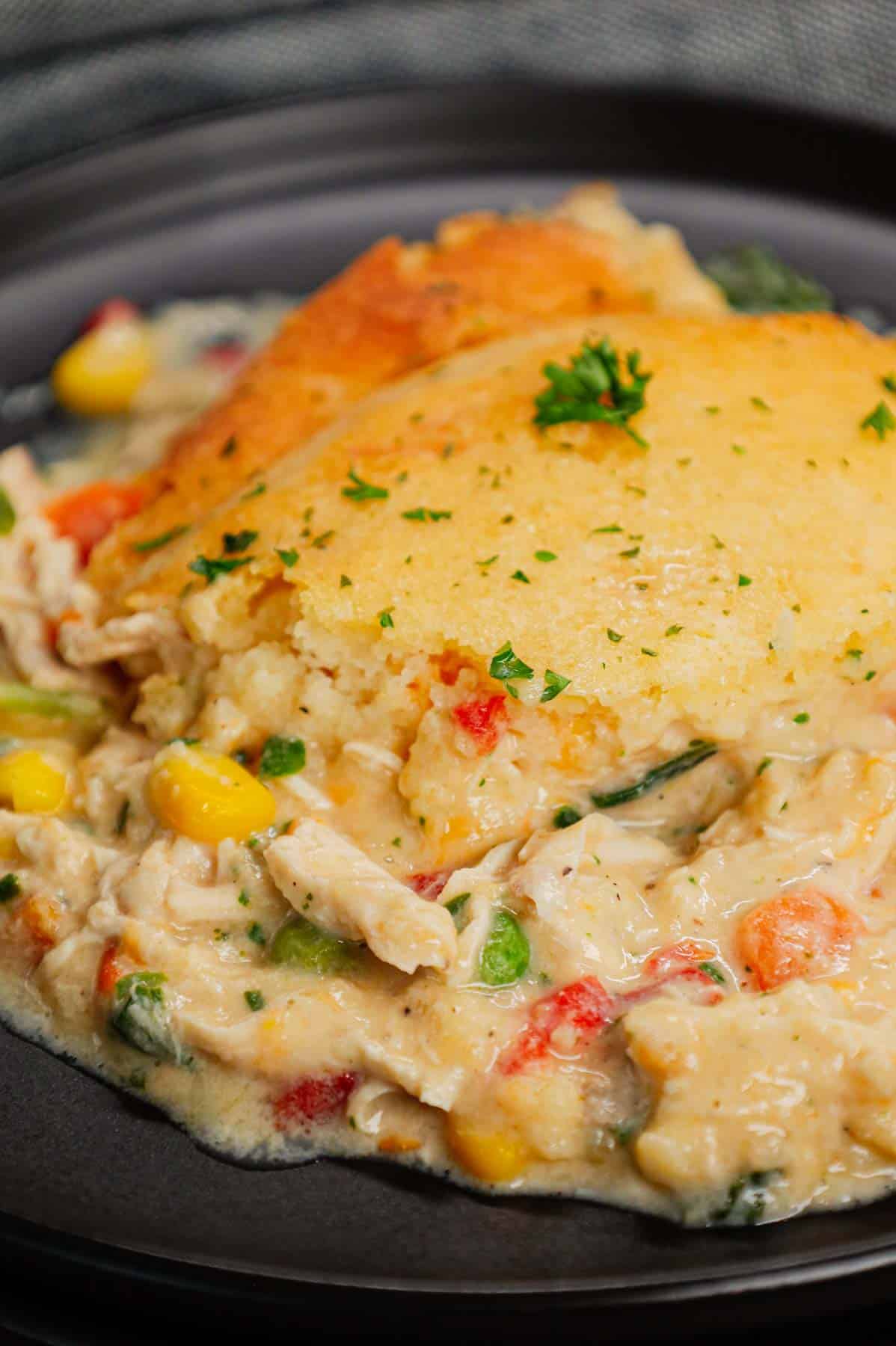 Chicken Cobbler is a hearty dish loaded with shredded rotisserie chicken and veggies all tossed in a mixture of cream of chicken and cream of mushroom soup and topped with Red Lobster Cheddar Bay biscuit mix.