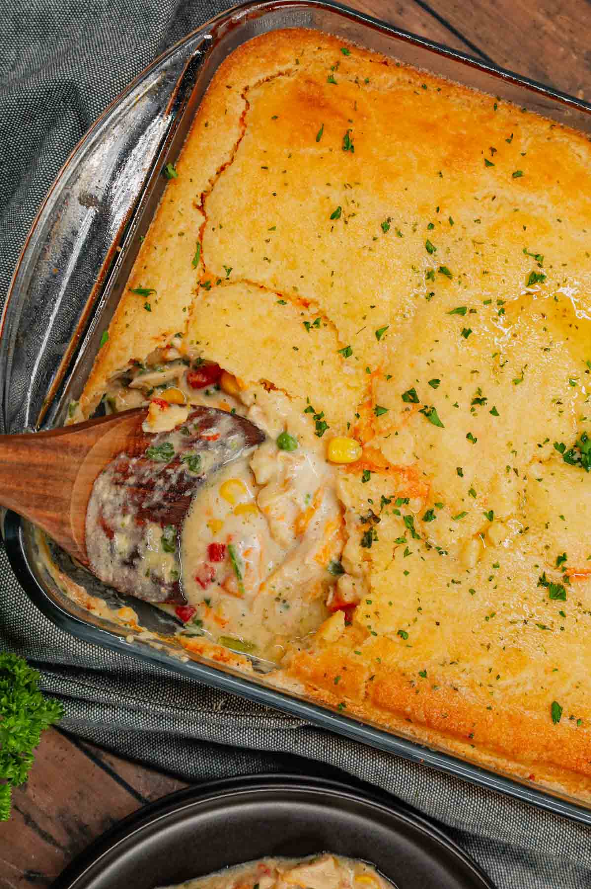 Chicken Cobbler is a hearty dish loaded with shredded rotisserie chicken and veggies all tossed in a mixture of cream of chicken and cream of mushroom soup and topped with Red Lobster Cheddar Bay biscuit mix.