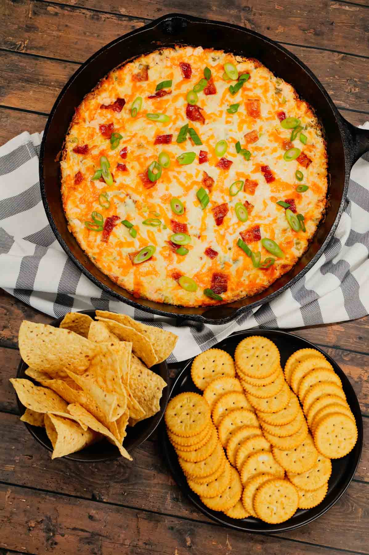 Crack Chicken Dip is a delicious baked dip loaded with shredded chicken, cream cheese, ranch dressing, bacon, green onions and cheddar cheese.