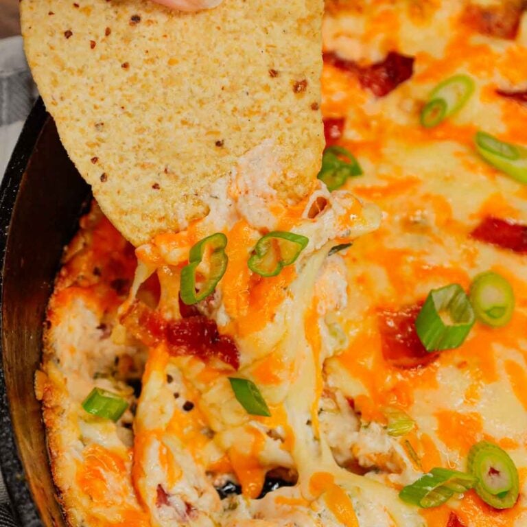 Crack Chicken Dip is a delicious baked dip loaded with shredded chicken, cream cheese, ranch dressing, bacon, green onions and cheddar cheese.