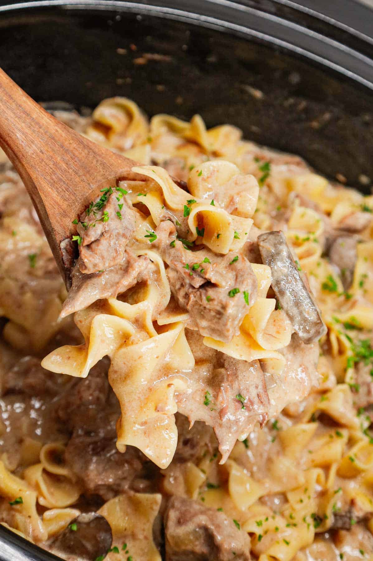 Crock Pot Beef Stroganoff is a hearty slow cooker dinner recipe loaded with tender chunks of stewing beef, sliced mushrooms, onions and egg noodles all in a delicious beef broth and cream of mushroom sauce.