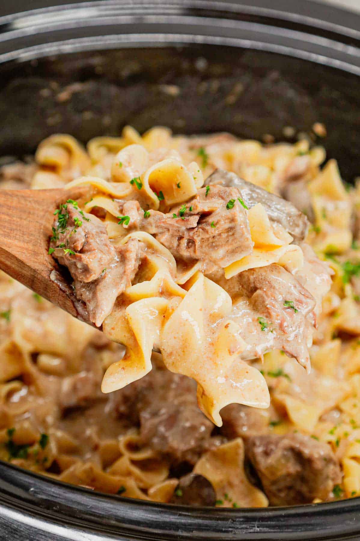 Crock Pot Beef Stroganoff is a hearty slow cooker dinner recipe loaded with tender chunks of stewing beef, sliced mushrooms, onions and egg noodles all in a delicious beef broth and cream of mushroom sauce.