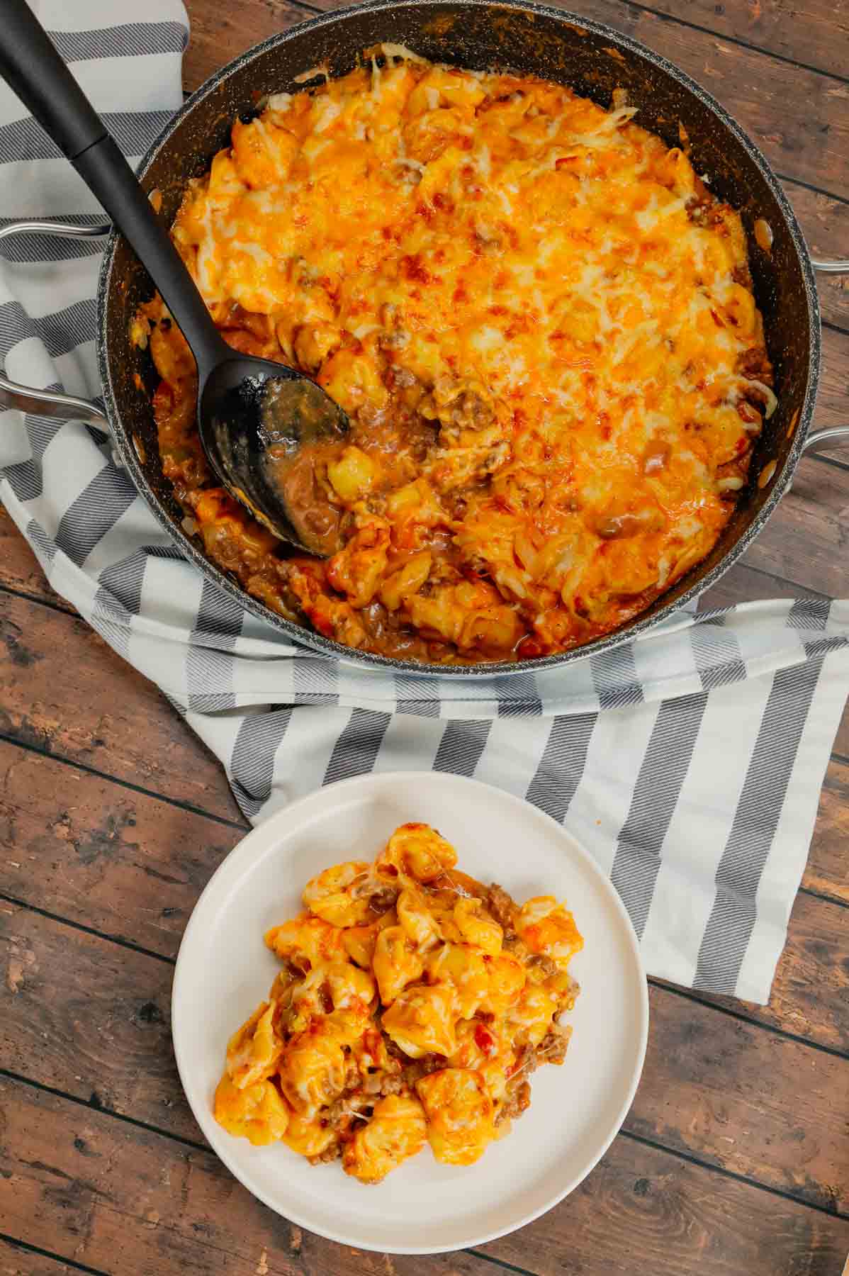 Cheeseburger Tortellini Skillet is a hearty pasta dish loaded with ground beef, frozen cheese tortellini, diced onions, cheddar soup, Rotel and shredded cheddar cheese.