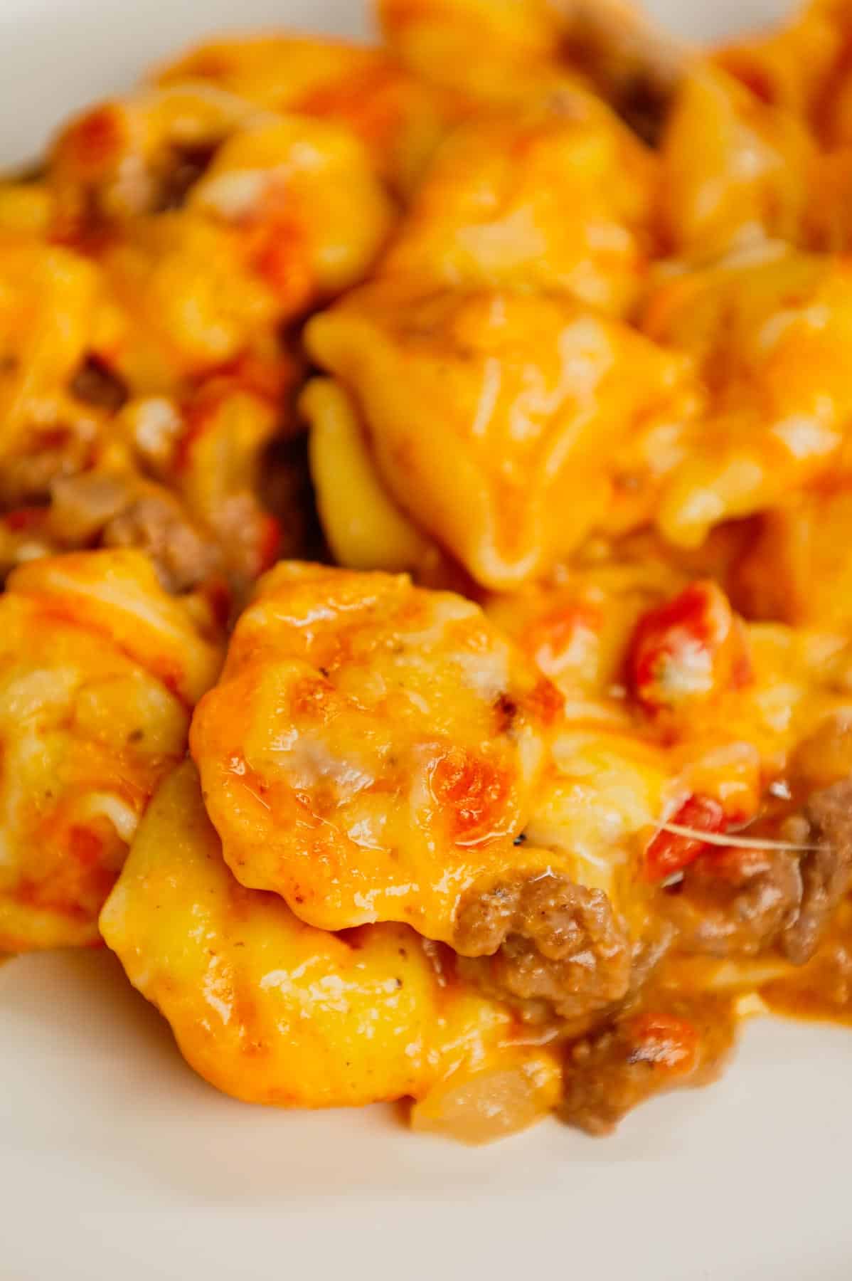 Cheeseburger Tortellini Skillet is a hearty pasta dish loaded with ground beef, frozen cheese tortellini, diced onions, cheddar soup, Rotel and shredded cheddar cheese.