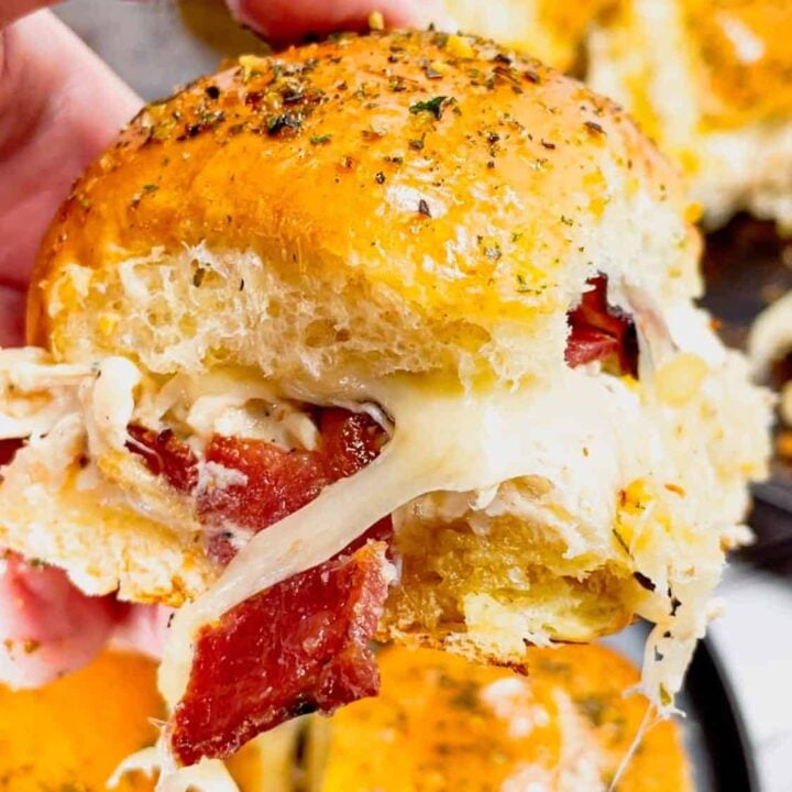 Garlic Parmesan Chicken Sliders are a delicious mini sandwich recipe loaded with shredded rotisserie chicken, bacon, provolone, mozzarella, cream cheese and Buffalo Wild Wings Parmesan Garlic Sauce.