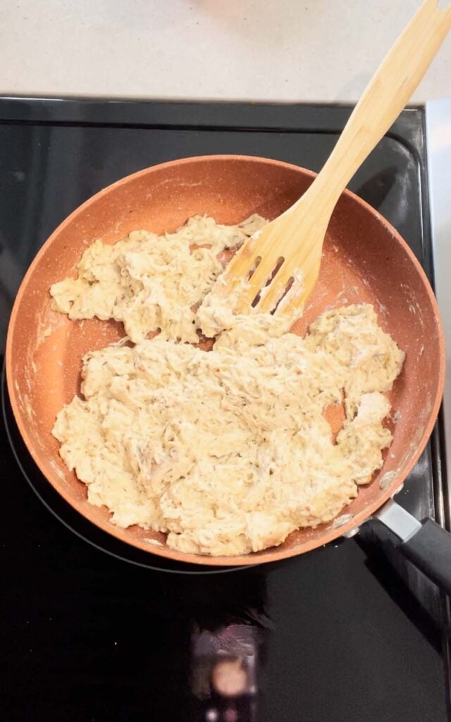 shredded chicken, cream cheese and parmesan garlic sauce mixture in a skillet