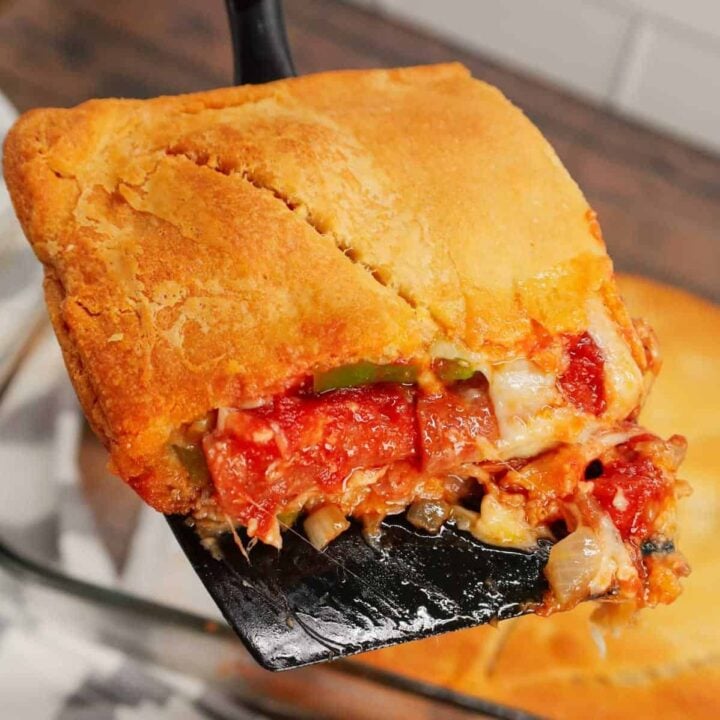 Pizza Pot Pie is a simple and delicious dinner recipe using Pillsbury crescent roll dough for the crust and filled with mozzarella cheese, pizza sauce, Italian sausage, onions, green peppers and pepperoni.