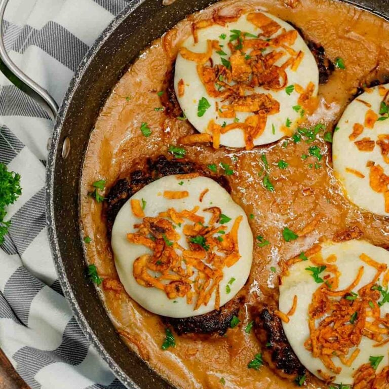 French Onion Hamburger Steaks are an easy ground beef dinner recipe with tender patties loaded with onion soup mix, crispy fried onions and provolone cheese all in a flavourful gravy.