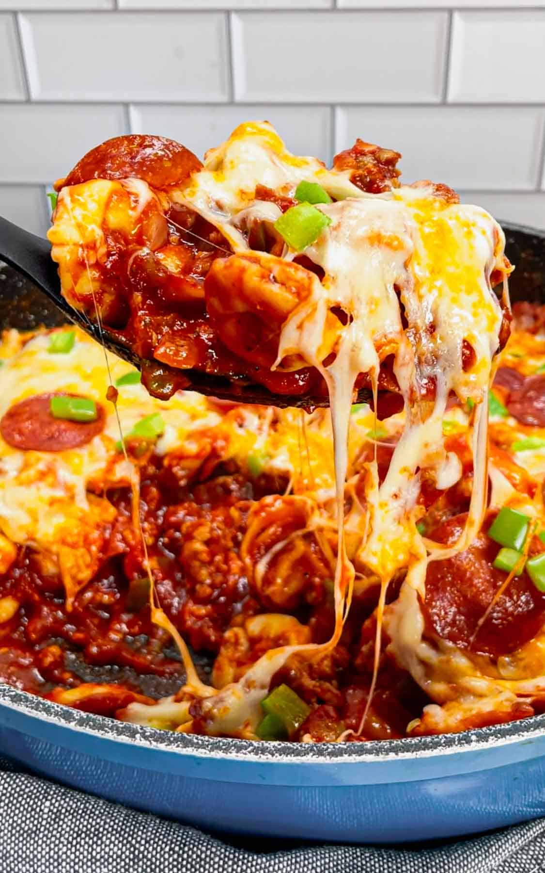 Pizza Tortellini is a hearty pasta dish loaded with Italian sausage meat, cheese tortellini, diced onions, green peppers, pepperoni, pizza sauce, pasta sauce and mozzarella cheese.