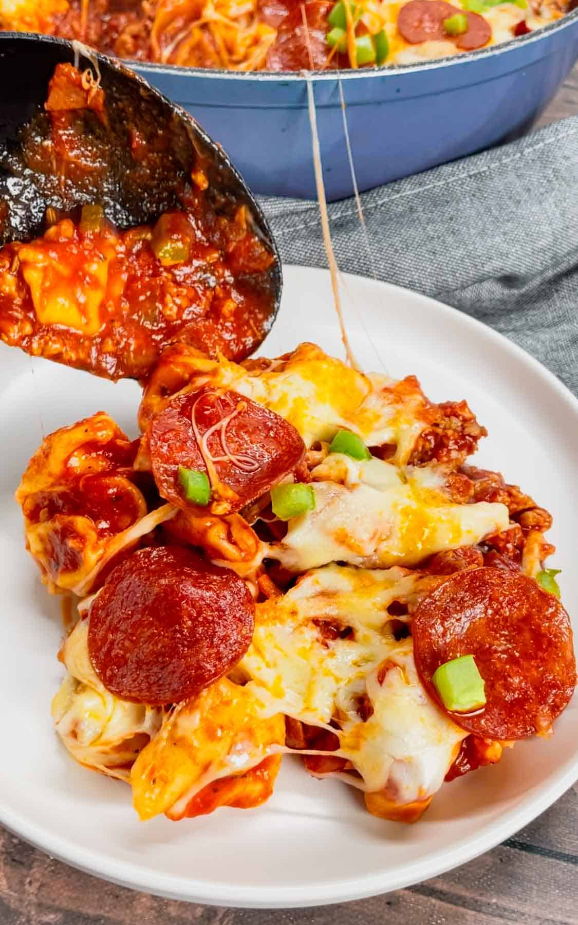 Pizza Tortellini is a hearty pasta dish loaded with Italian sausage meat, cheese tortellini, diced onions, green peppers, pepperoni, pizza sauce, pasta sauce and mozzarella cheese.