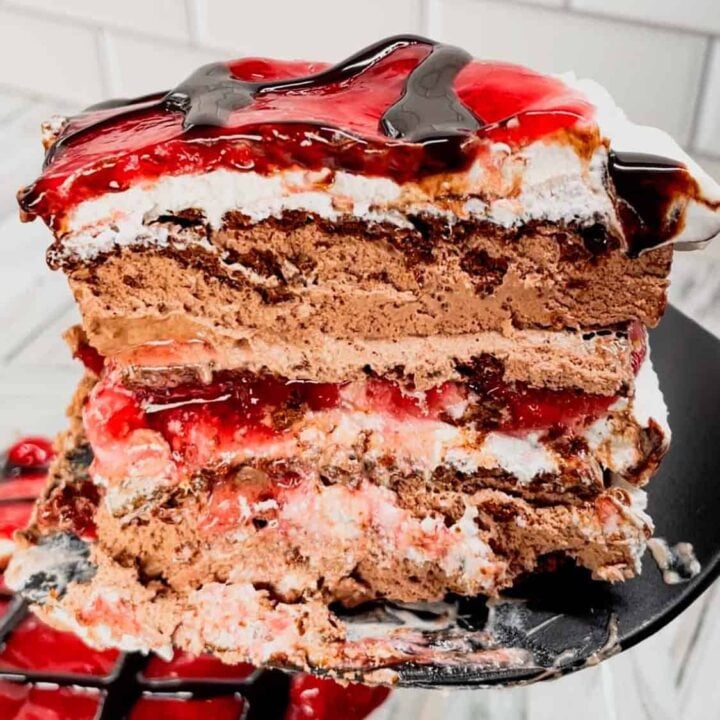 Black Forest Ice Cream Sandwich Cake is an easy 4 ingredient no bake dessert recipe made with chocolate ice cream sandwiches, whipped topping, cherry pie filling and chocolate sauce.