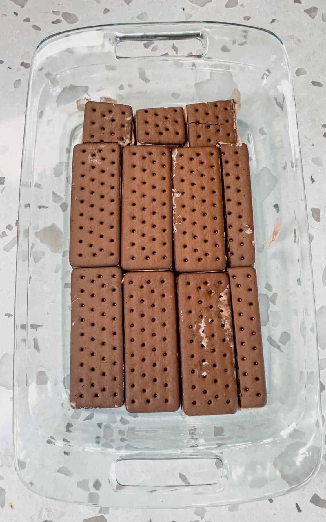 chocolate ice cream sandwiches in the bottom of a baking dish