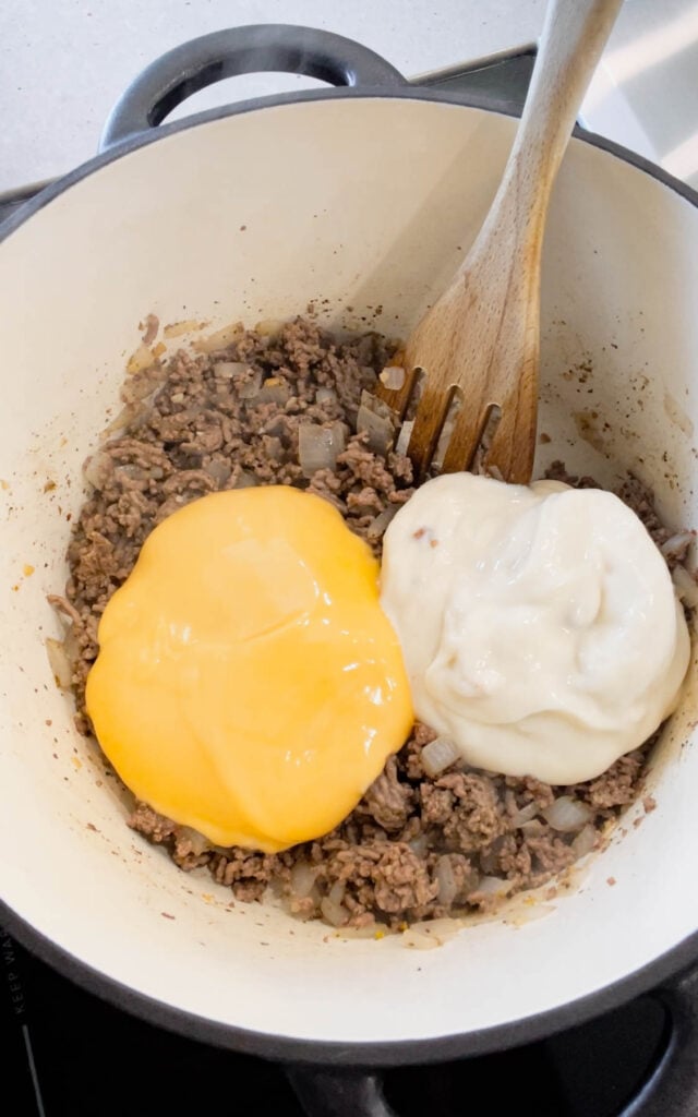 cheddar soup and cream of bacon soup added to pot with cooked ground beef