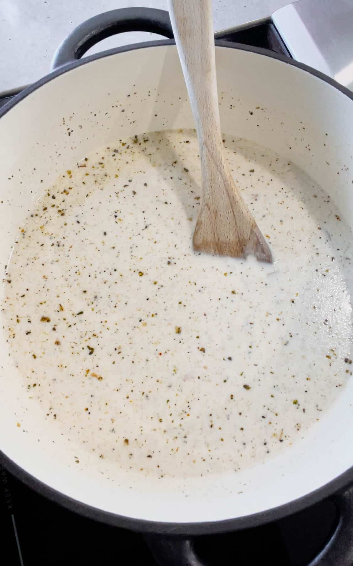 stirring cream soup mixture in a Dutch oven