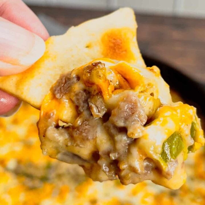 Philly Cheese Steak Dip is a tasty hot dip recipe loaded with chopped roast beef, green pepper, onions, Montreal steak spice, cottage cheese, Laughing Cow cheese and shredded cheddar and mozzarella.