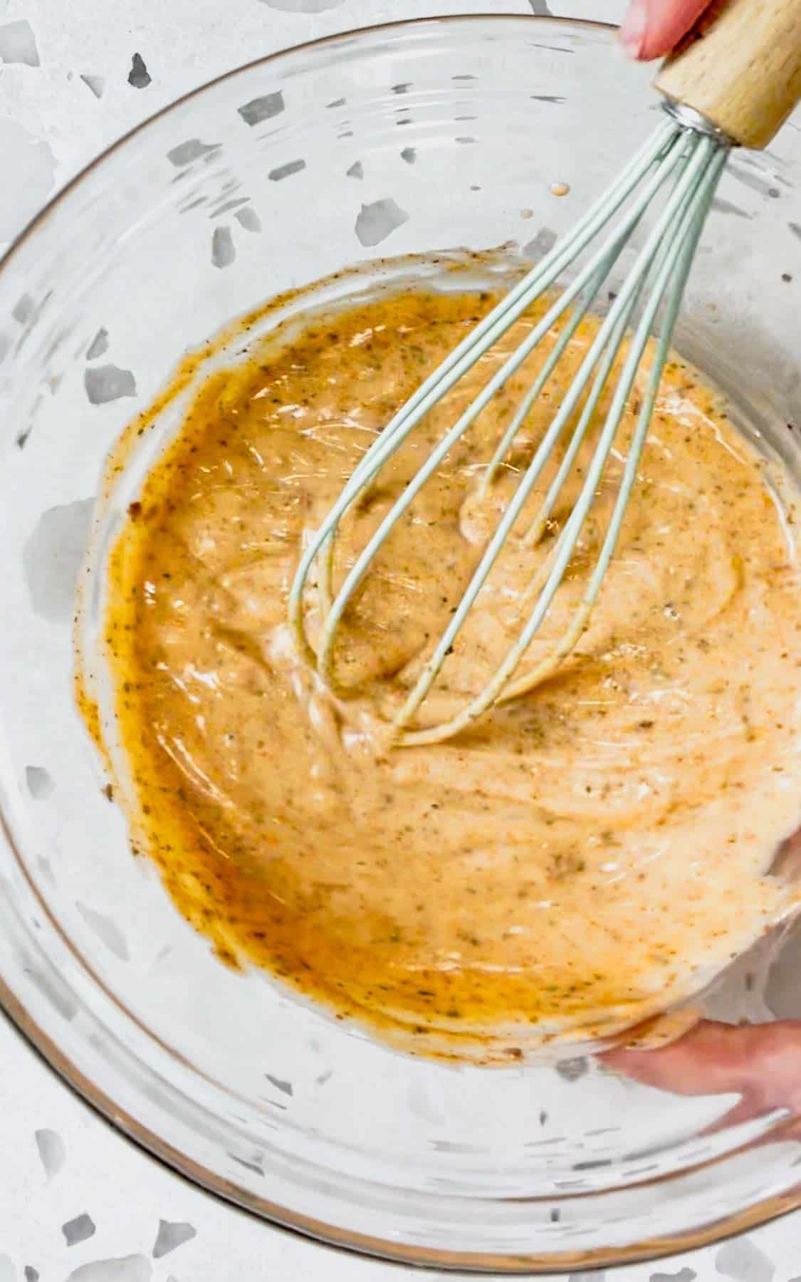 Cajun alfredo sauce in a mixing bowl