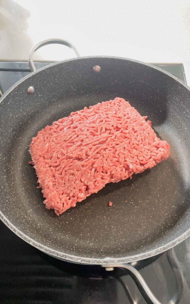 raw ground beef in a skillet
