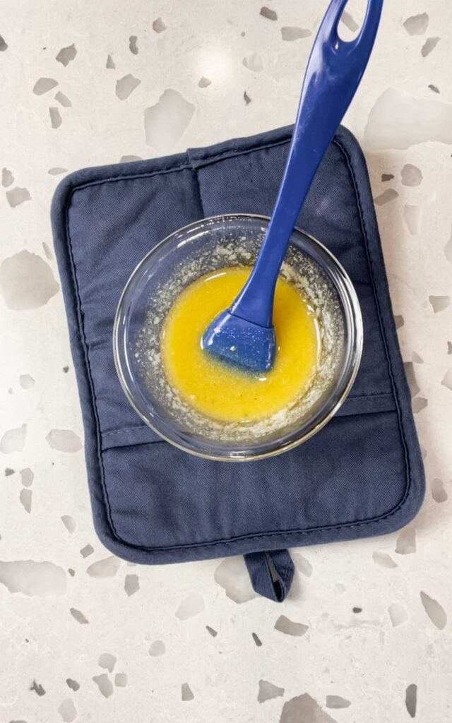 melted butter and cheddar bay seasoning mix in a small glass bowl