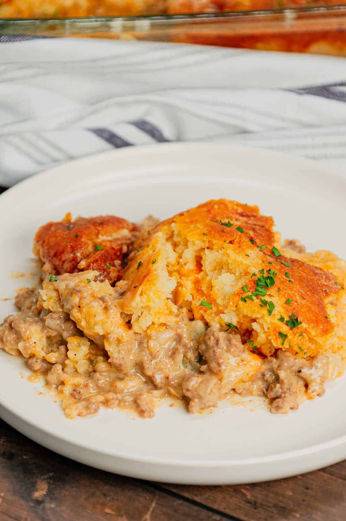 Cheddar Bay Ground Beef Cobbler is a hearty casserole recipe with a creamy and cheesy ground beef base and a Red Lobster Cheddar Bay Biscuit topping.