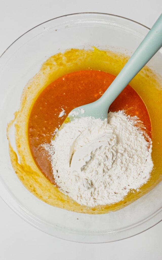 all purpose flour added to bowl with orange brownie batter