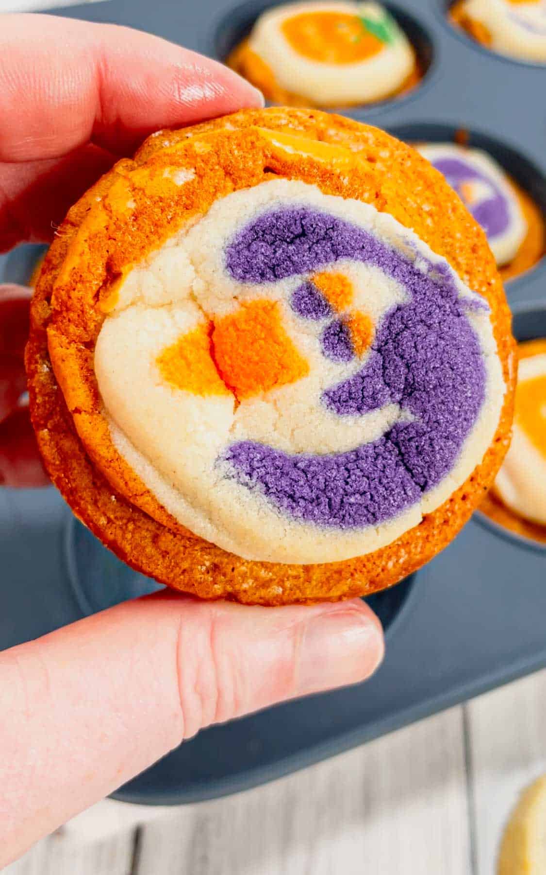 Halloween Sugar Cookie Brownies are a fun and tasty treat made in muffin tins with a dyed orange brownie base topped with Pillsbury Halloween sugar cookies.