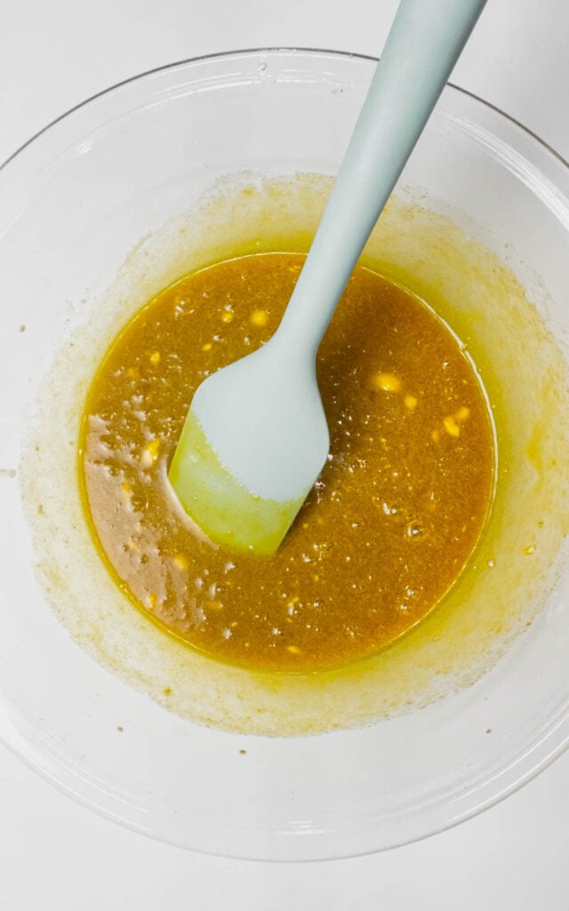 brownie batter after stirring in yellow food colouring