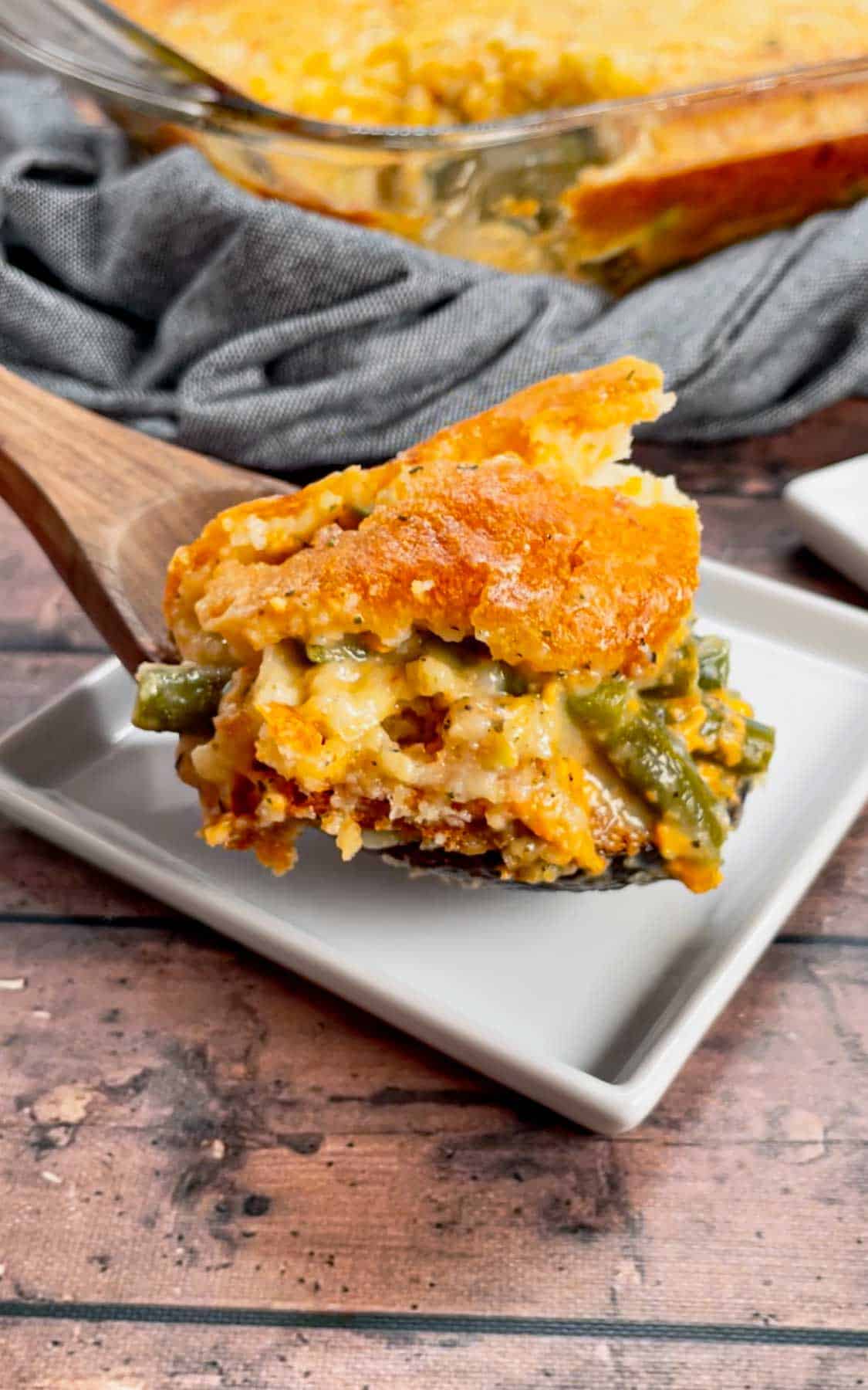 Take your holiday side dish game to the next level with this Cheddar Bay Green Bean Casserole—a creamy, cheesy twist with an irresistible biscuit topping that'll have everyone coming back for seconds! This hearty green bean casserole is loaded with cheddar soup, shredded parmesan and shredded cheddar cheese all covered with a layer Red Lobster Cheddar Bay Biscuits.