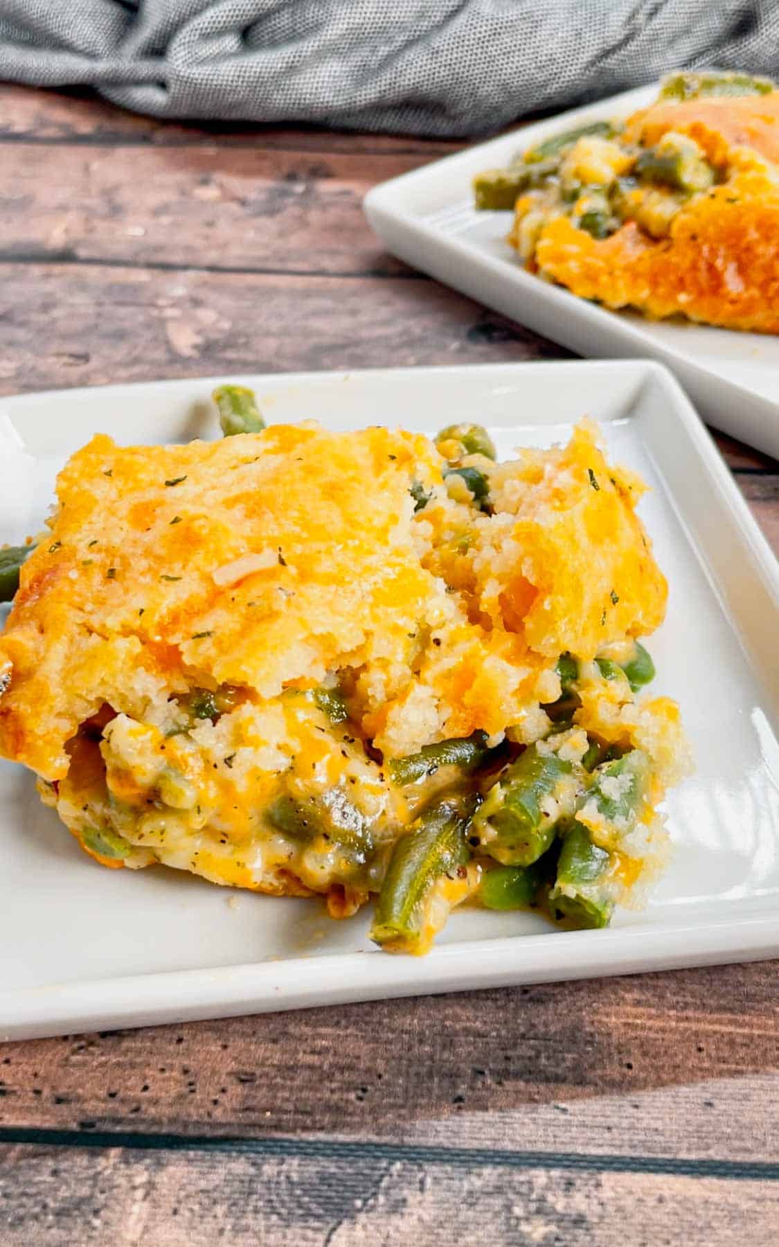 Take your holiday side dish game to the next level with this Cheddar Bay Green Bean Casserole—a creamy, cheesy twist with an irresistible biscuit topping that'll have everyone coming back for seconds! This hearty green bean casserole is loaded with cheddar soup, shredded parmesan and shredded cheddar cheese all covered with a layer Red Lobster Cheddar Bay Biscuits.