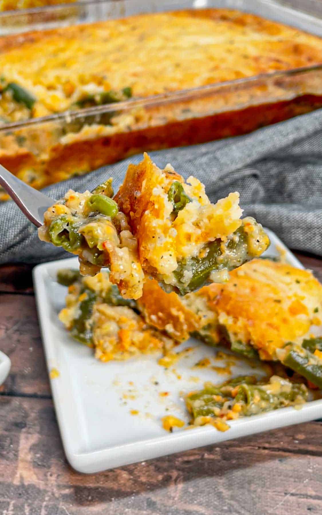 Take your holiday side dish game to the next level with this Cheddar Bay Green Bean Casserole—a creamy, cheesy twist with an irresistible biscuit topping that'll have everyone coming back for seconds! This hearty green bean casserole is loaded with cheddar soup, shredded parmesan and shredded cheddar cheese all covered with a layer Red Lobster Cheddar Bay Biscuits.