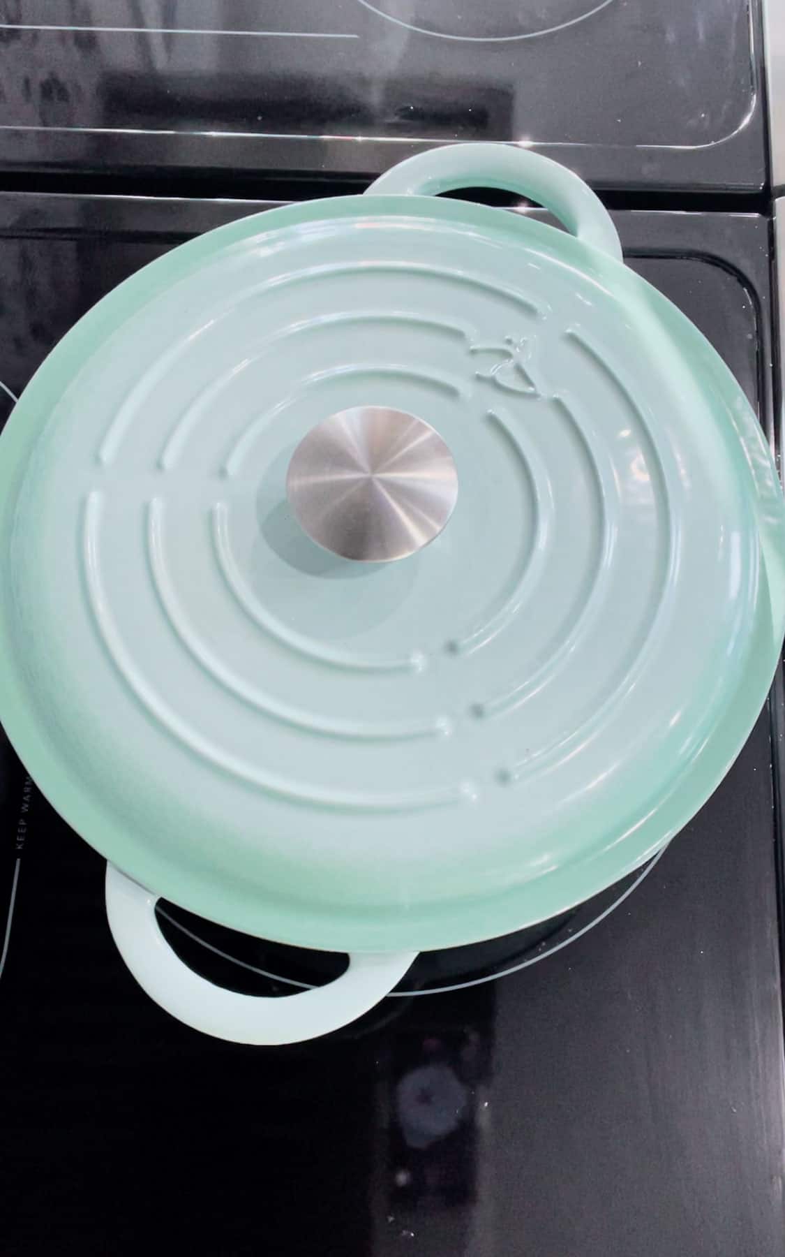 dutch oven with the lid on sitting on the stove