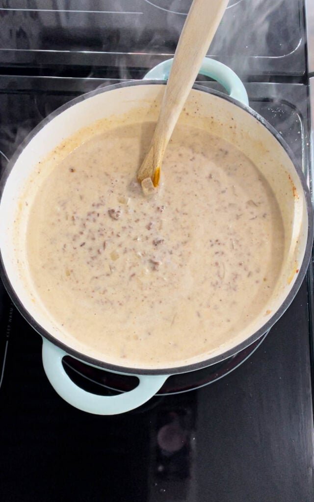 stirring spices into cheeseburger soup