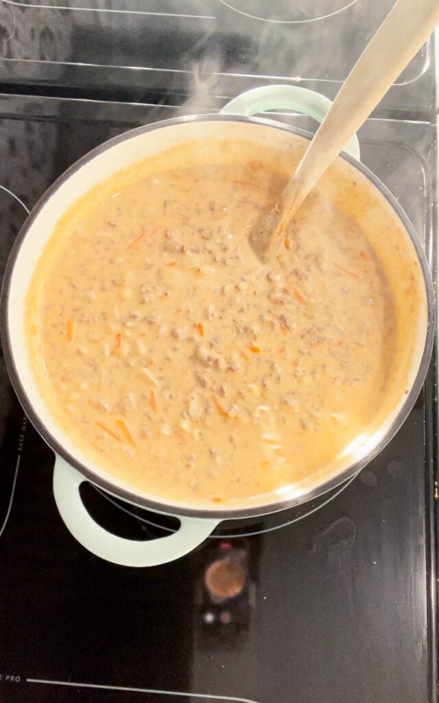 If you love the flavors of a classic cheeseburger, this creamy, cheesy Cheeseburger Macaroni Soup will become your new favorite comfort food—ready in just one pot and guaranteed to satisfy every craving! This hearty soup is loaded with ground beef, matchstick carrots, macaroni noodles, cheddar cheese, parmesan cheese, chicken broth and heavy cream.