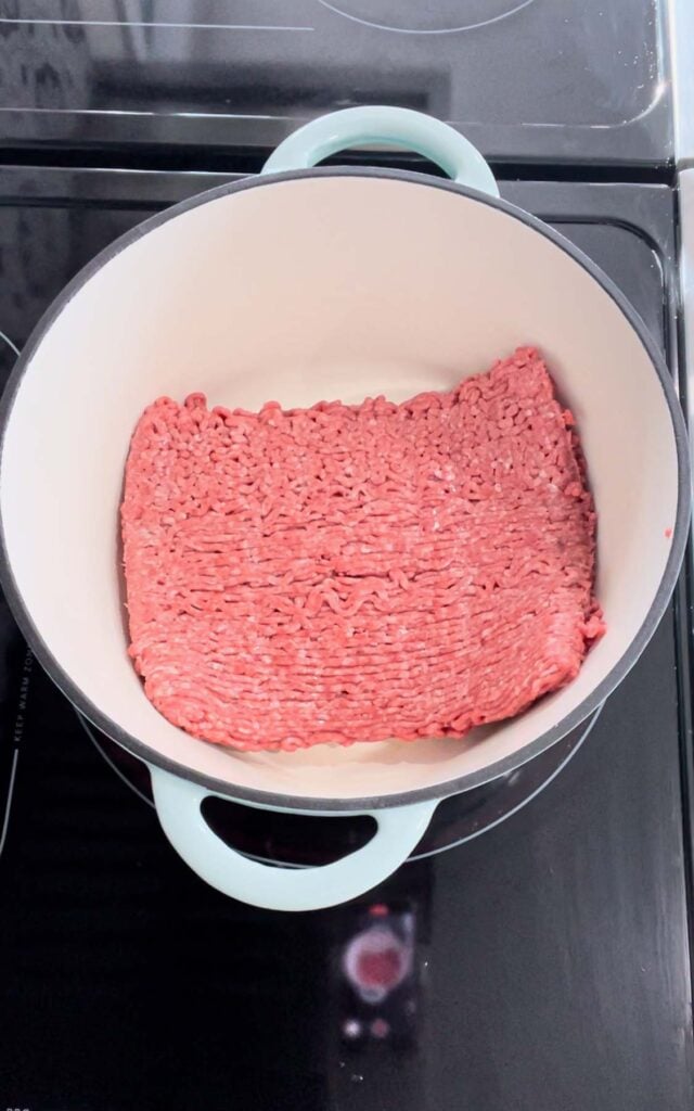 raw ground beef in a large dutch oven