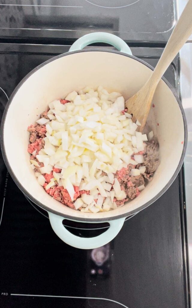 diced onions added to dutch oven with ground beef