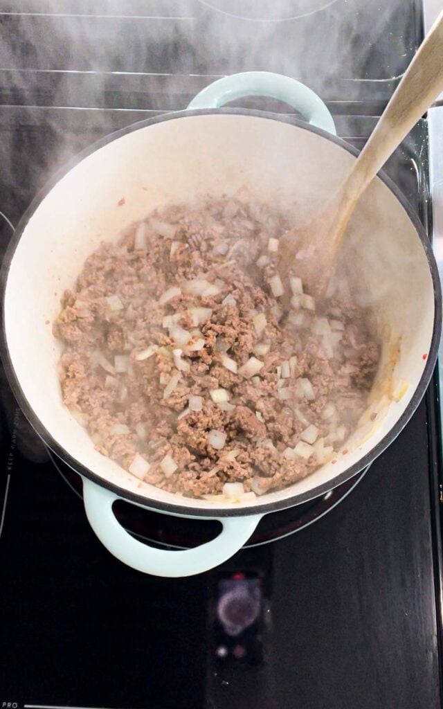 cooked ground beef and onions in a dutch oven