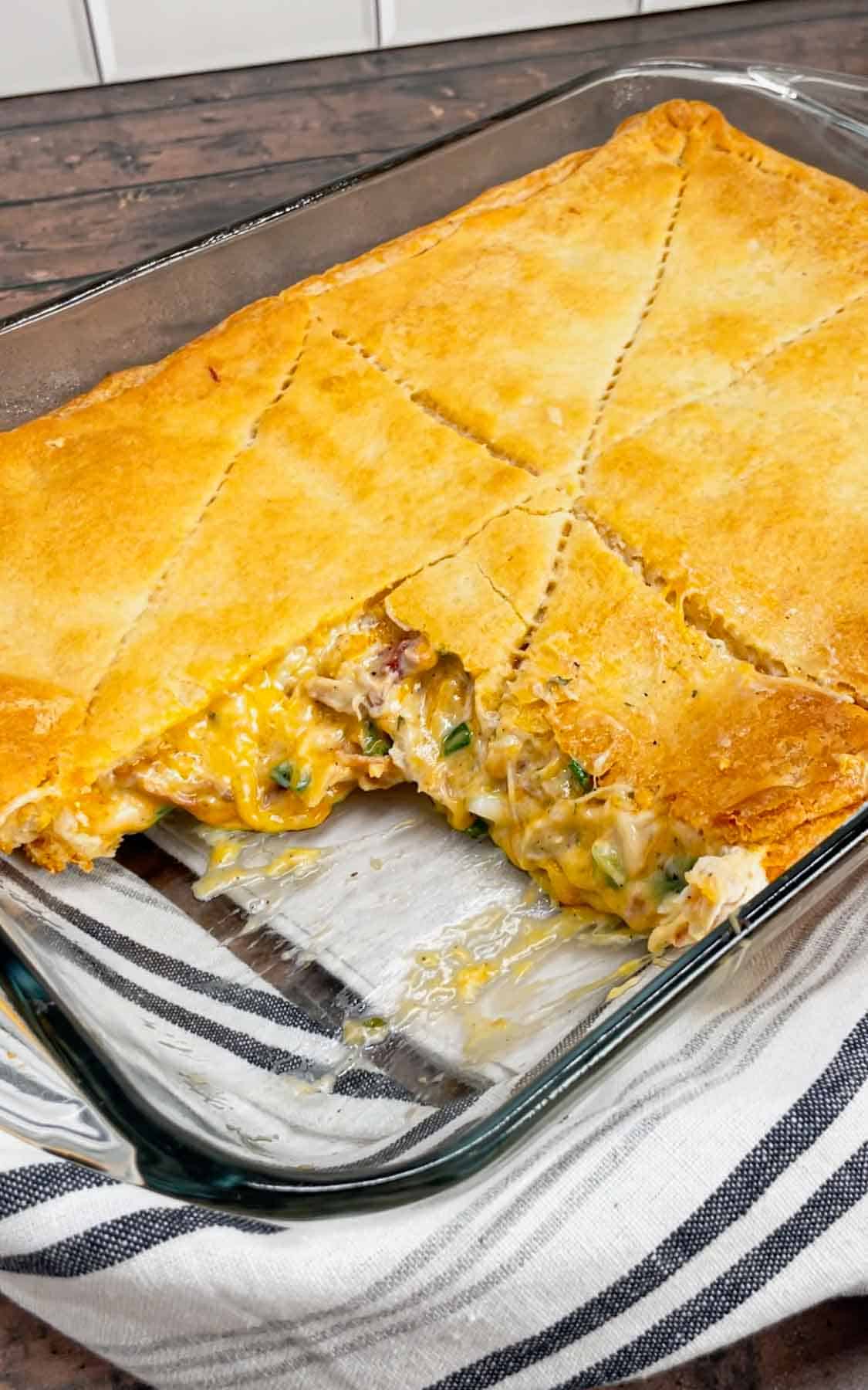 Get ready to fall head over heels for this Crack Chicken Pot Pie with Crescent Rolls—where creamy, cheesy, bacon-packed goodness meets buttery, flaky perfection! This hearty dish is loaded with shredded rotisserie chicken, bacon, ranch seasoning, green onions and cheddar cheese all in a creamy sauce and baked between two layers of Pillsbury crescent rolls.
