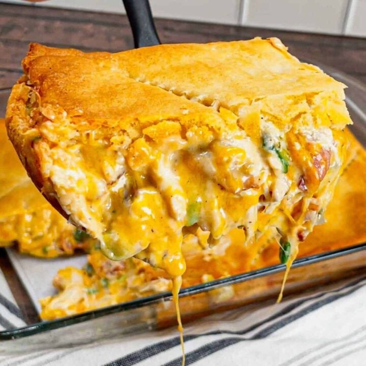 Get ready to fall head over heels for this Crack Chicken Pot Pie with Crescent Rolls—where creamy, cheesy, bacon-packed goodness meets buttery, flaky perfection! This hearty dish is loaded with shredded rotisserie chicken, bacon, ranch seasoning, green onions and cheddar cheese all in a creamy sauce and baked between two layers of Pillsbury crescent rolls.