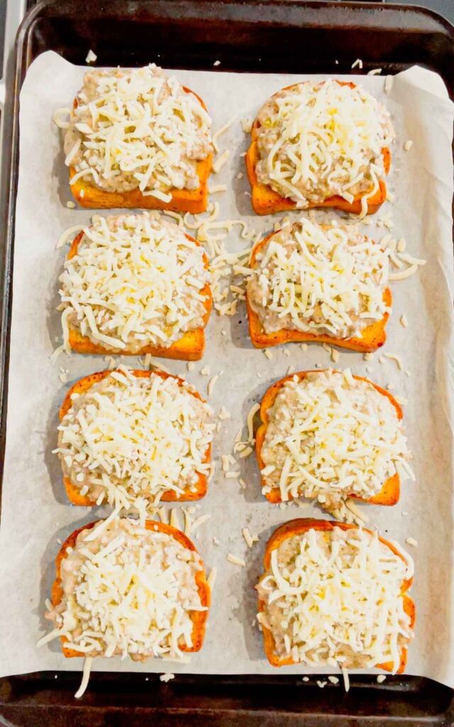 garlic parmesan texas toast sloppy joes with shredded mozzarella cheese on top on a baking sheet