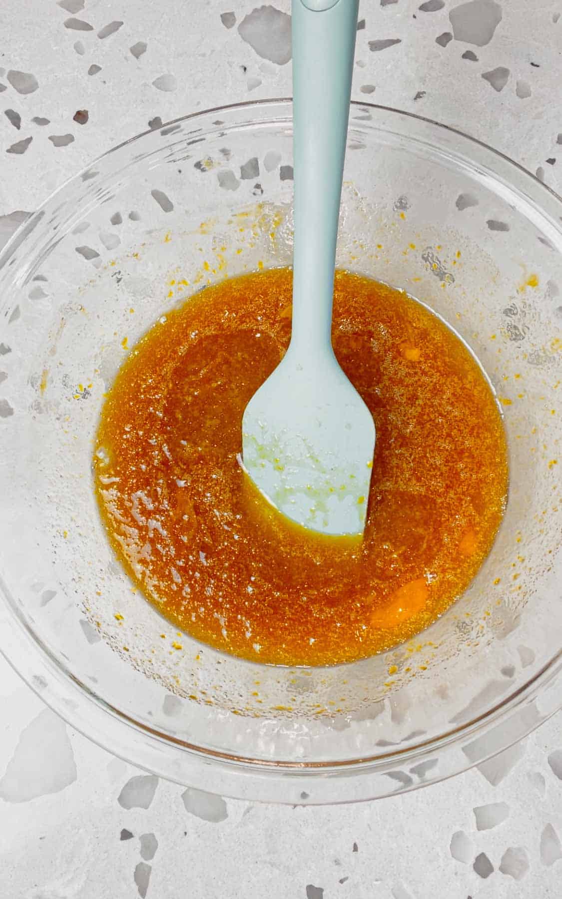 stirring together brown sugar, corn syrup, eggs and melted butter in a glass bowl