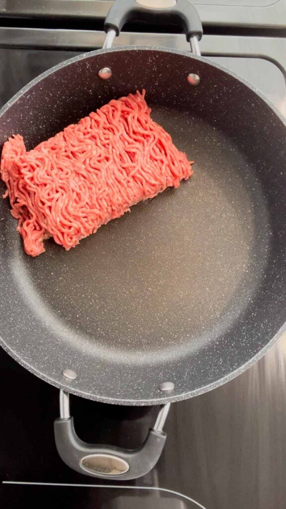 raw ground beef in a skillet
