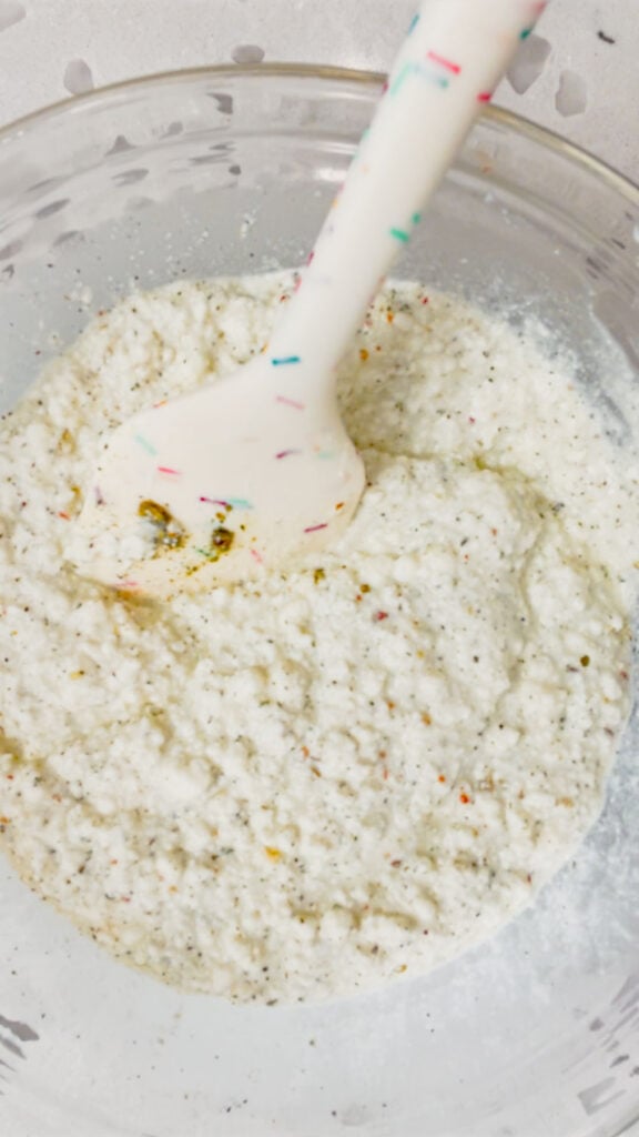 ricotta, milk and seasoning mixture in a bowl