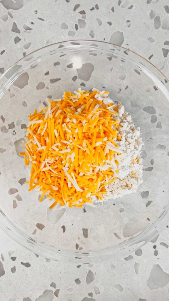 shredded cheddar cheese in a bowl with Cheddar Bay biscuit mix