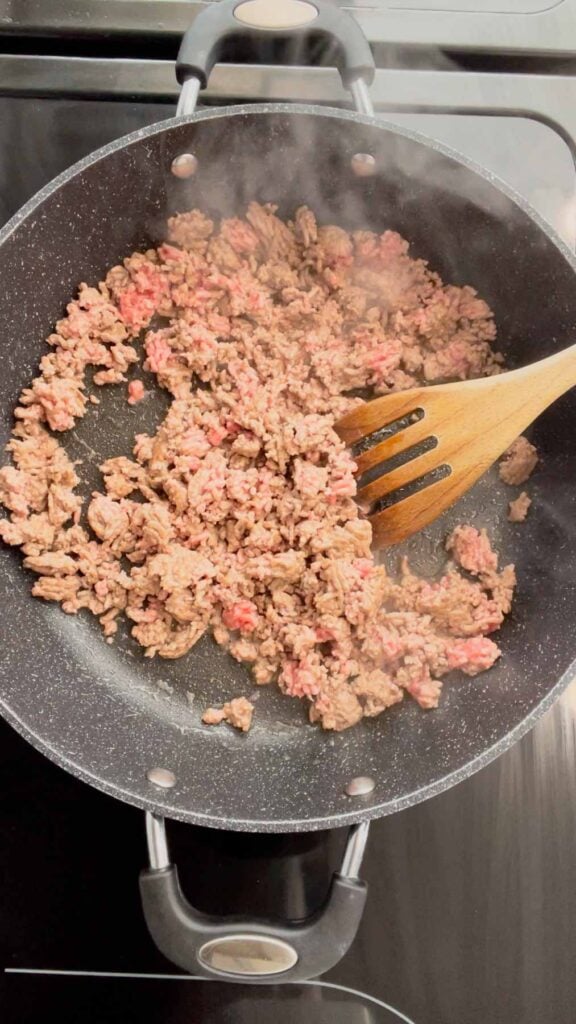 crumbling ground beef in a skillet