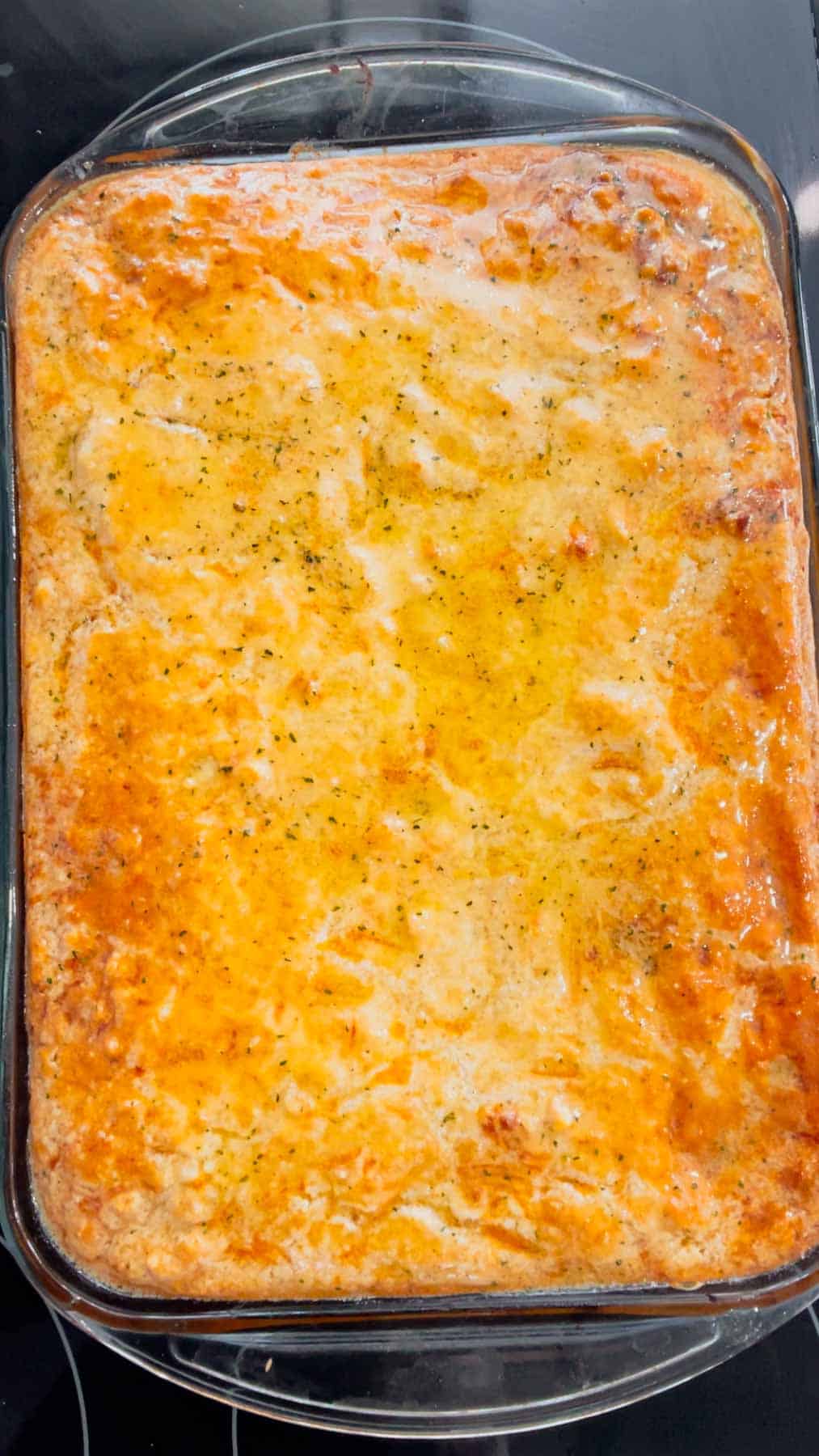 butter and seasoning brushed on top of cheddar bay biscuit spaghetti casserole