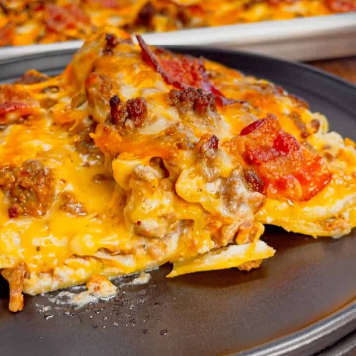 Imagine all the cheesy, meaty, bacon-packed goodness of a classic bacon cheeseburger layered into a rich, bubbly, and ridiculously easy sheet pan lasagna—your new favorite weeknight comfort food! This hearty dish is loaded with ground beef, cheddar sauce, ricotta, cheddar cheese, bacon, lasagna noodles, bacon and cream of bacon soup.