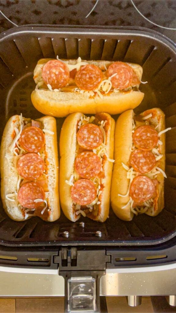 pepperoni pizza hot dogs in an air fryer basket before cooking