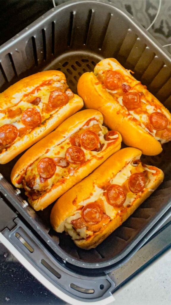 pepperoni pizza hot dogs in an air fryer basket after cooking